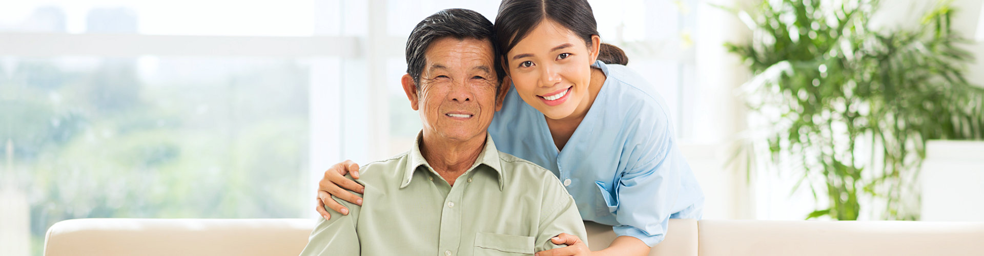 senior man and caregiver smiling