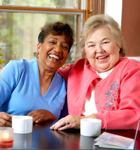 caregiver and senior woman smiling