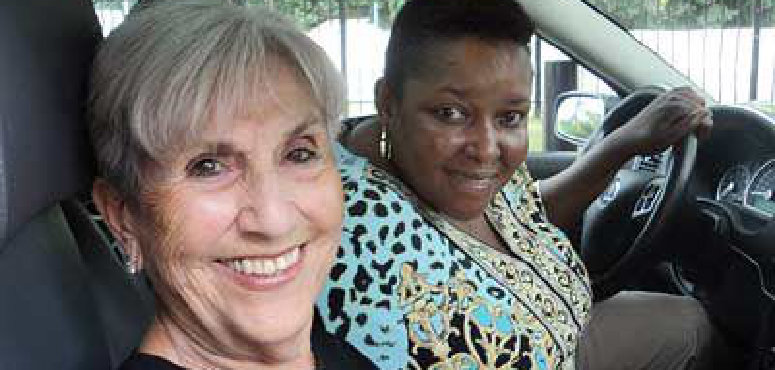 two senior woman at the car