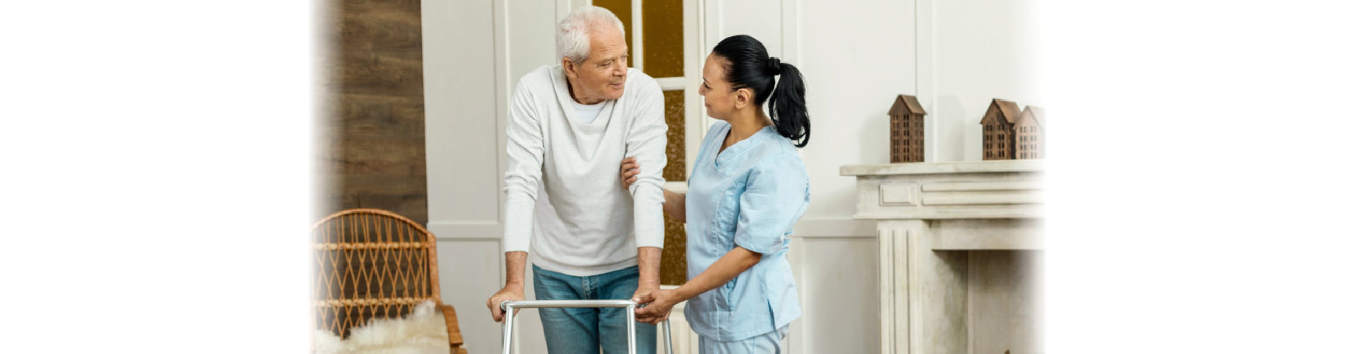 caregiver assisting elderly man walking