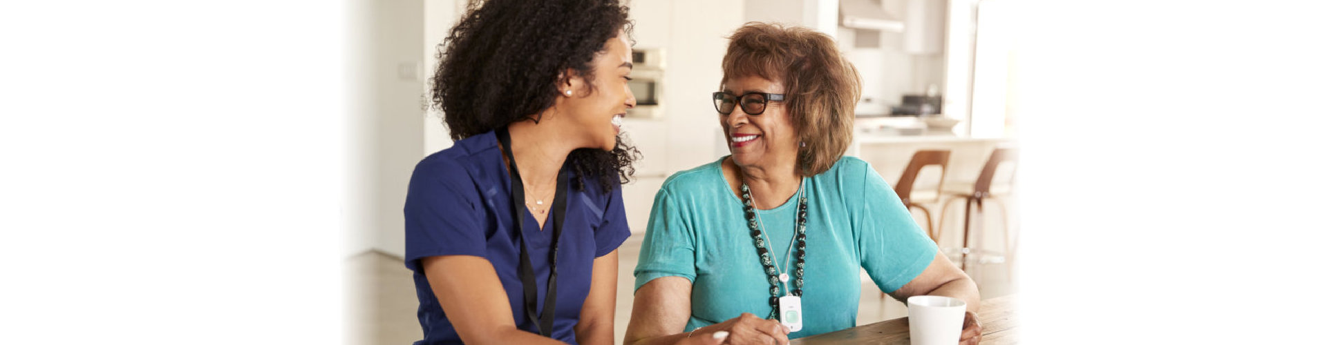 caregiver and elderly woman laughing