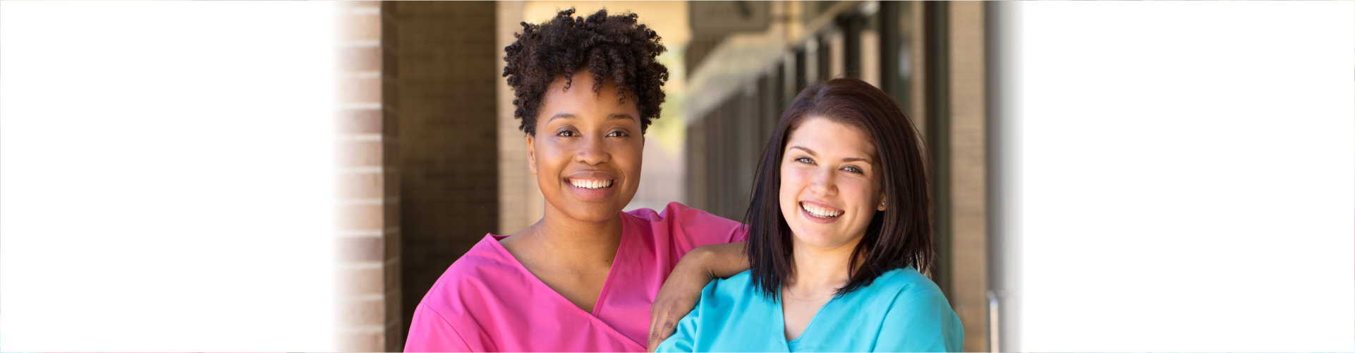 two caregivers smiling