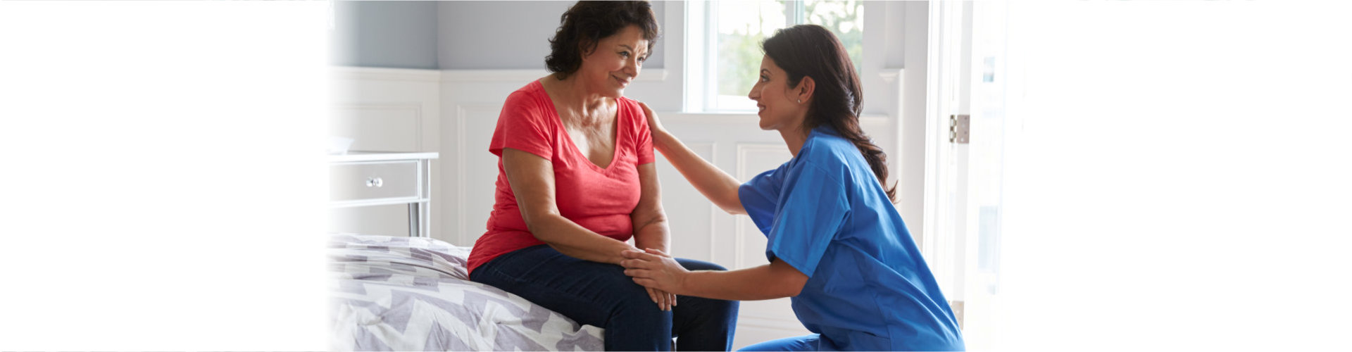 caregiver and elderly woman looking at each other