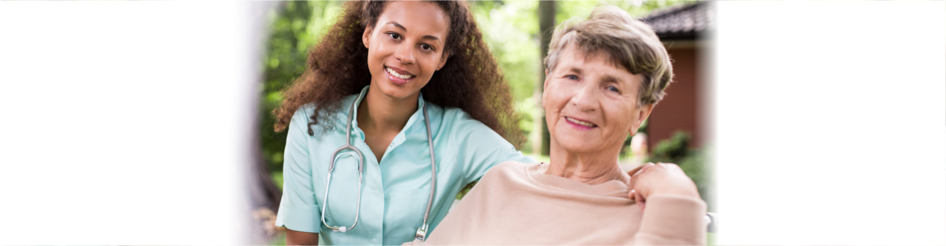 caregiver and elderly woman smiling