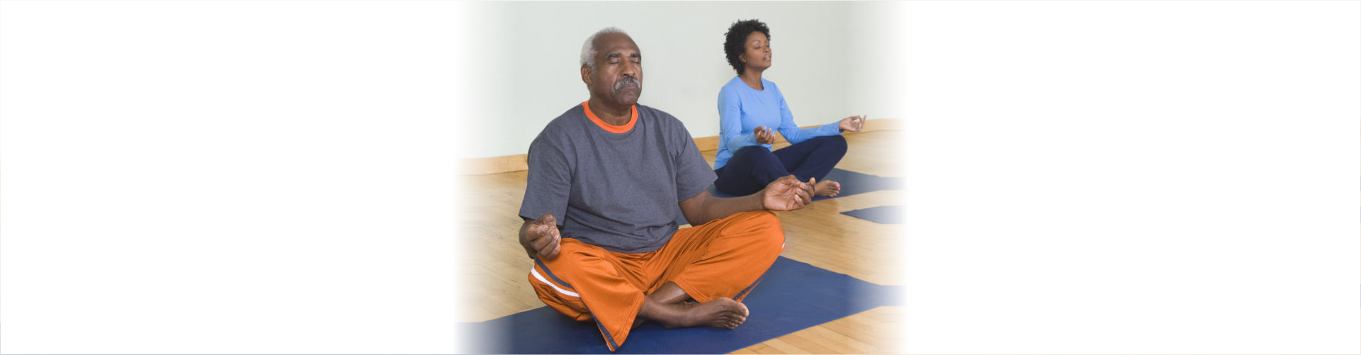 senior man and woman doing yoga