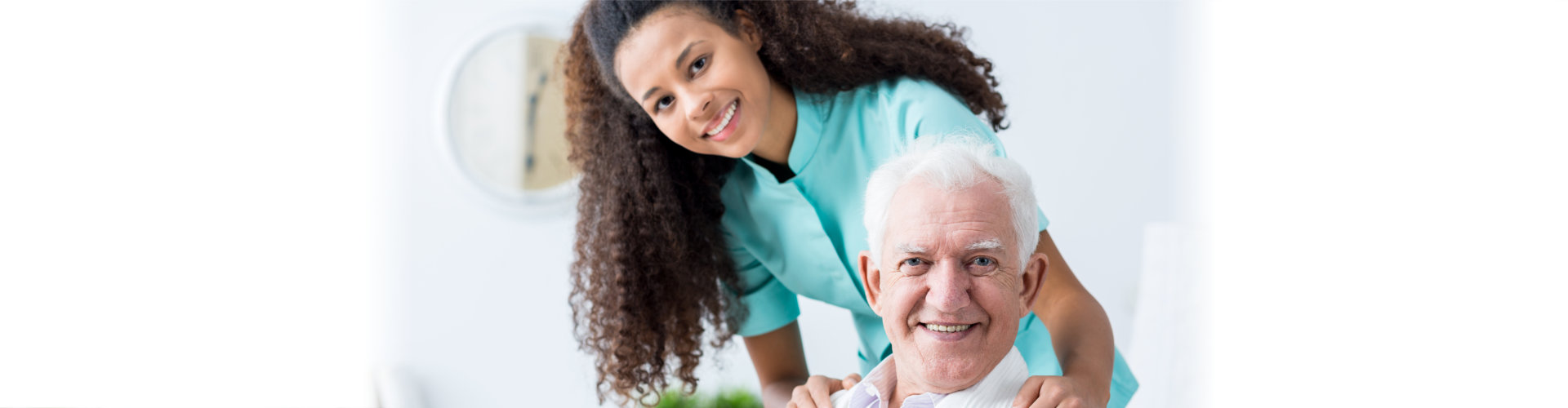 elderly man and caregiver smiling